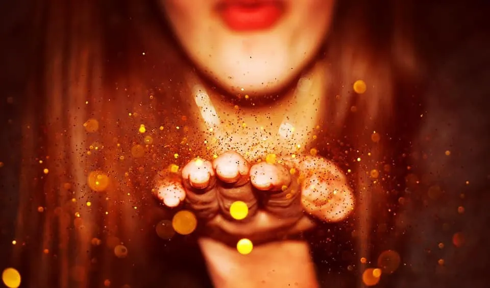 Golden sparkles blown from cupped hands